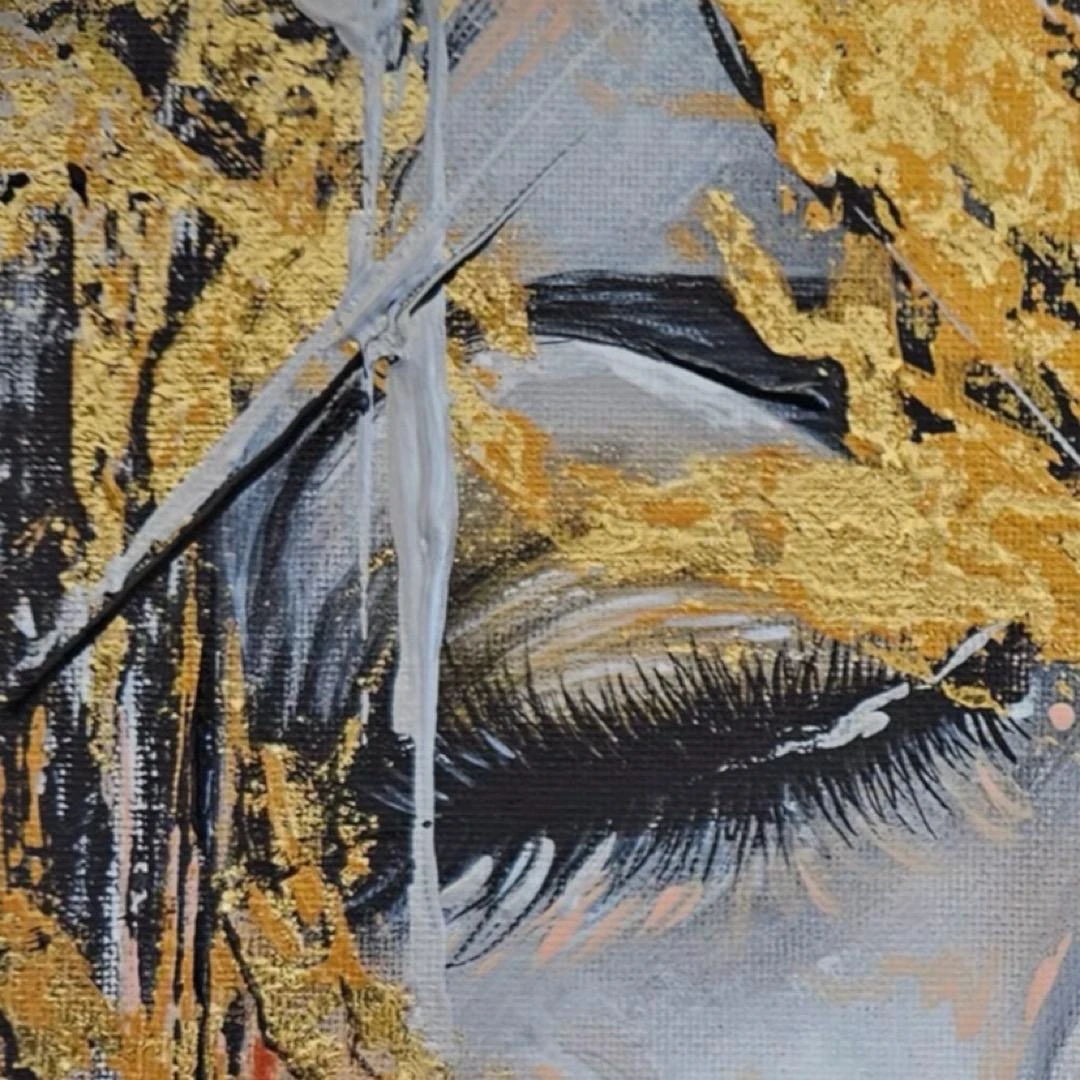 Close-up of a painted eyelid surrounded by textured gold and gray brushwork